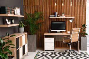 Modern office with wood paneling, light wood furniture, and plants in Decatur Illinois