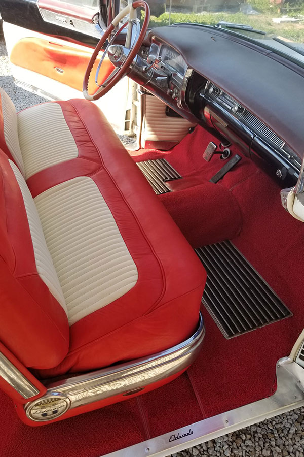 A read and cream-colored reupholstered car seats in Springfield, IL. Get quality reupholstery services from our furniture shop.
