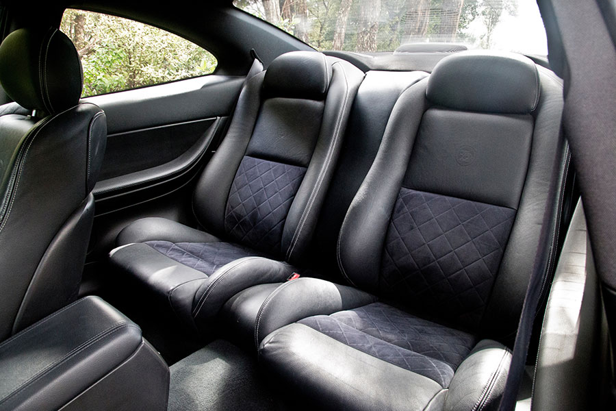 Two dark grey leather seats of a vehicle in Springfield, IL that a professional furniture store reupholstered.